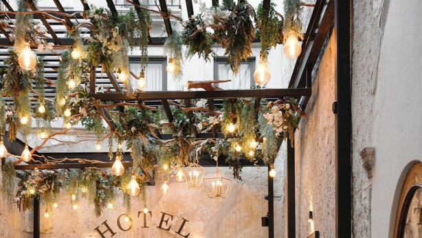 An indoor dining area with wooden tables and chairs, a stone floor, and a sign that reads "HOTEL". - Casa 63 Hotel Boutique & Spa (San Miguel de Allende)