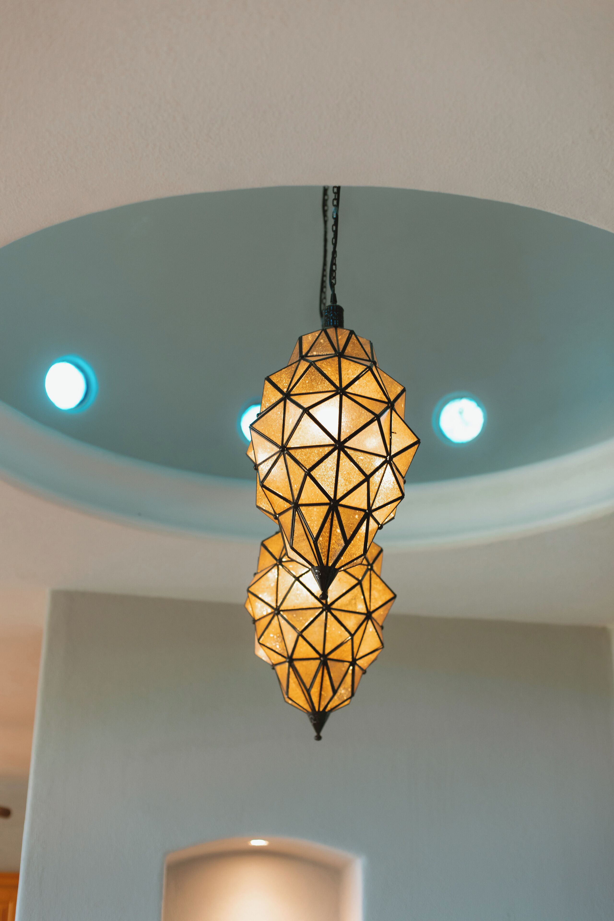 Un luminaire suspendu de forme géométrique, fixé au plafond.