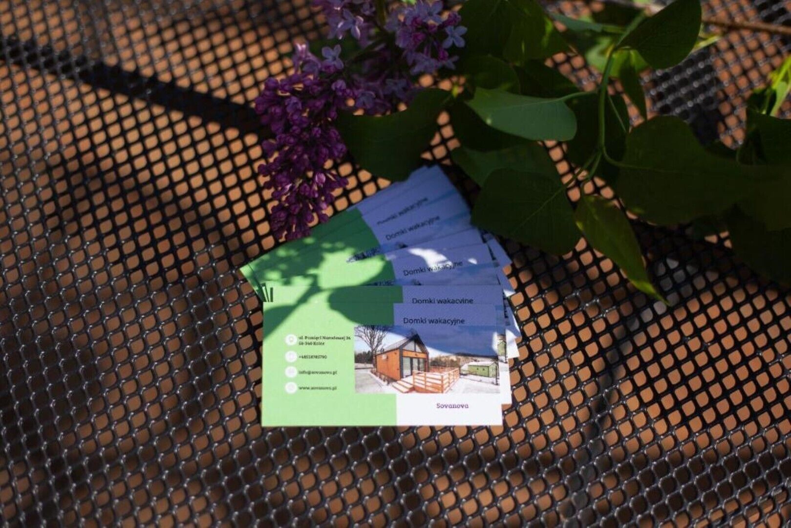 A brochure with a house image and text on a metal table.