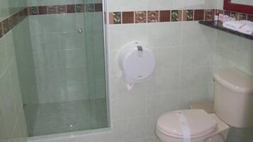 A bathroom with a toilet, a shower, and a towel rack.