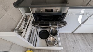 A kitchen with a built-in oven, a microwave, and a stainless steel range hood.