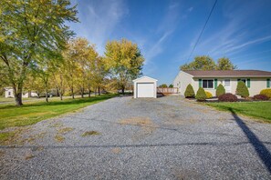 Drive up to a charming two-story home with a garage and beautifully landscaped surroundings.