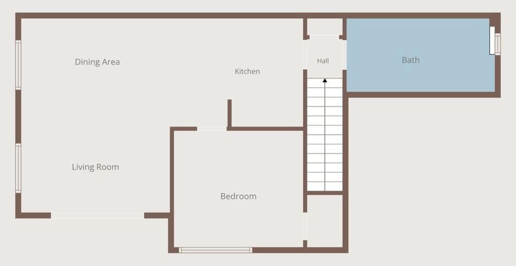 Un plan d’étage comprenant un coin repas, une cuisine, un salon, une chambre et une salle de bain.