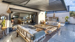 An open-plan living area with a dining area, a sofa set, and a coffee table.