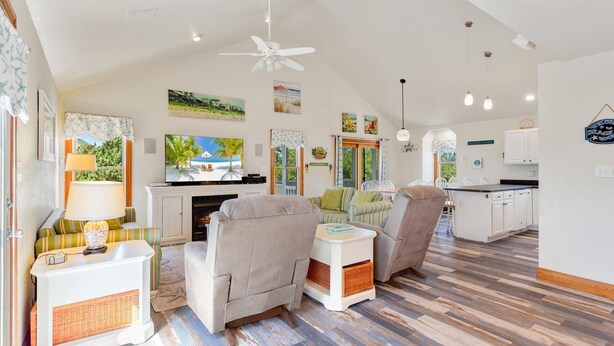 A spacious living area with a fireplace, comfortable seating, a television, and a kitchen area. - 4 br, loft, dog friendly, pool firepit! (Avon)