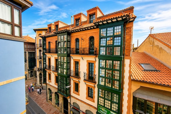 A multi-story building with a traditional architectural style, featuring balconies and large windows.