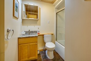 A bathroom with a toilet, sink, and shower. - The Big Lift-abowski 3BA/2BA. Close to Mountain and Skiing! (Killington)
