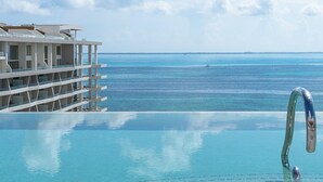 A pool with a clear view of the ocean and distant land. - 2 Bedroom Swim Up Suite Cancun (Cancun)