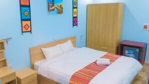A bedroom with a bed, wooden wardrobe, and a small table. - Homestay An Huy Mai Châu (Mai Chau)