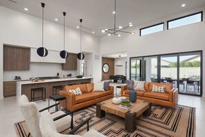 A modern interior with a kitchen, dining area, and living room. - Luna Luxe - Pool Heat Avail- Hot Tub - Fire Pit! (Scottsdale)