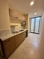 Family Suite | Private kitchen | Mini-fridge, microwave, electric kettle, cookware/dishes/utensils