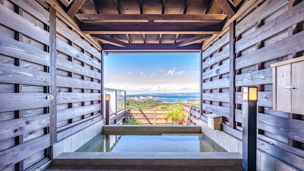 A modern interior with wooden paneling and a view of a landscape through an open space. - Nanki shirahama View point (Shirahama)