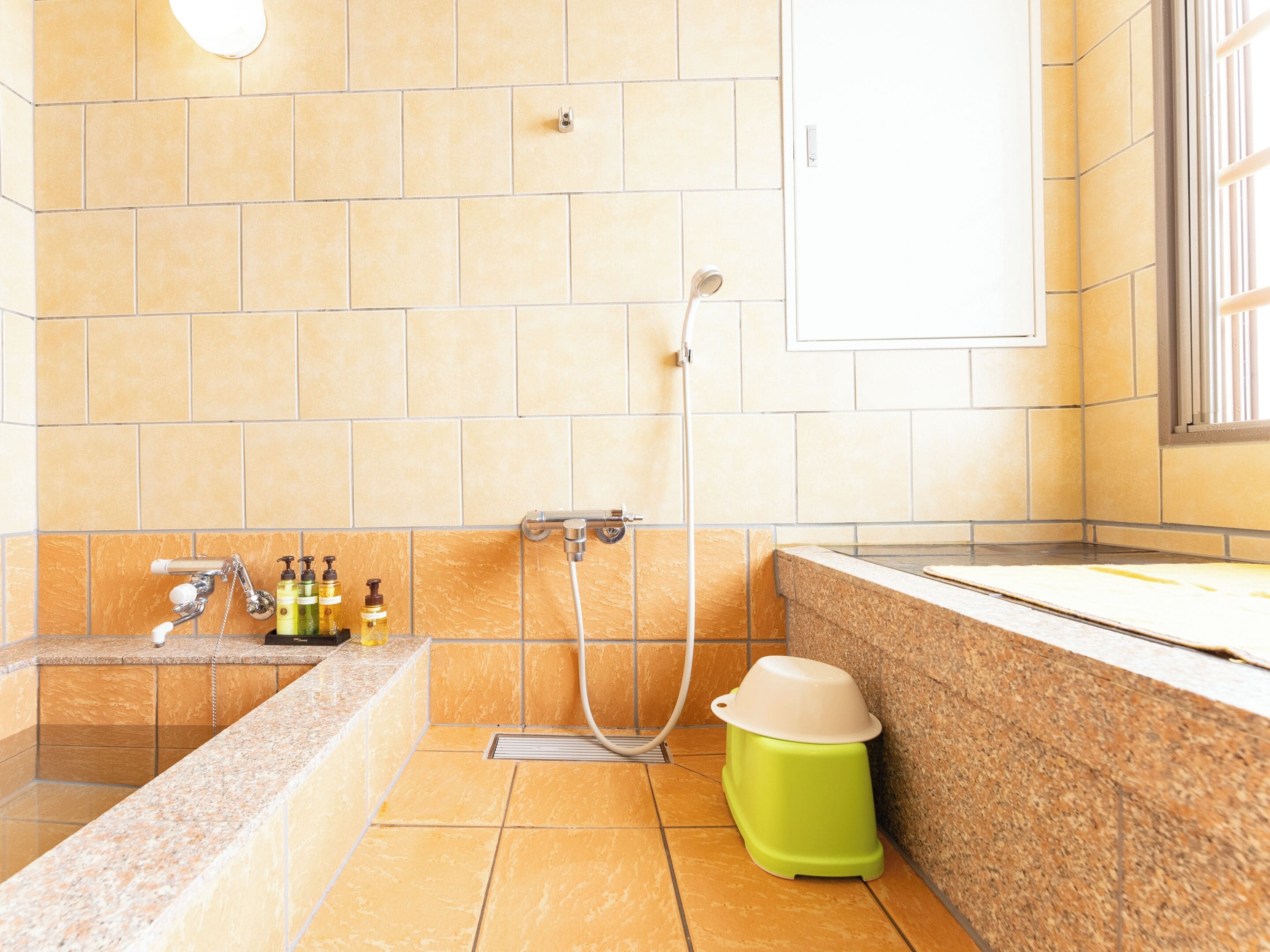 A bathroom with a bathtub, shower, and sink.