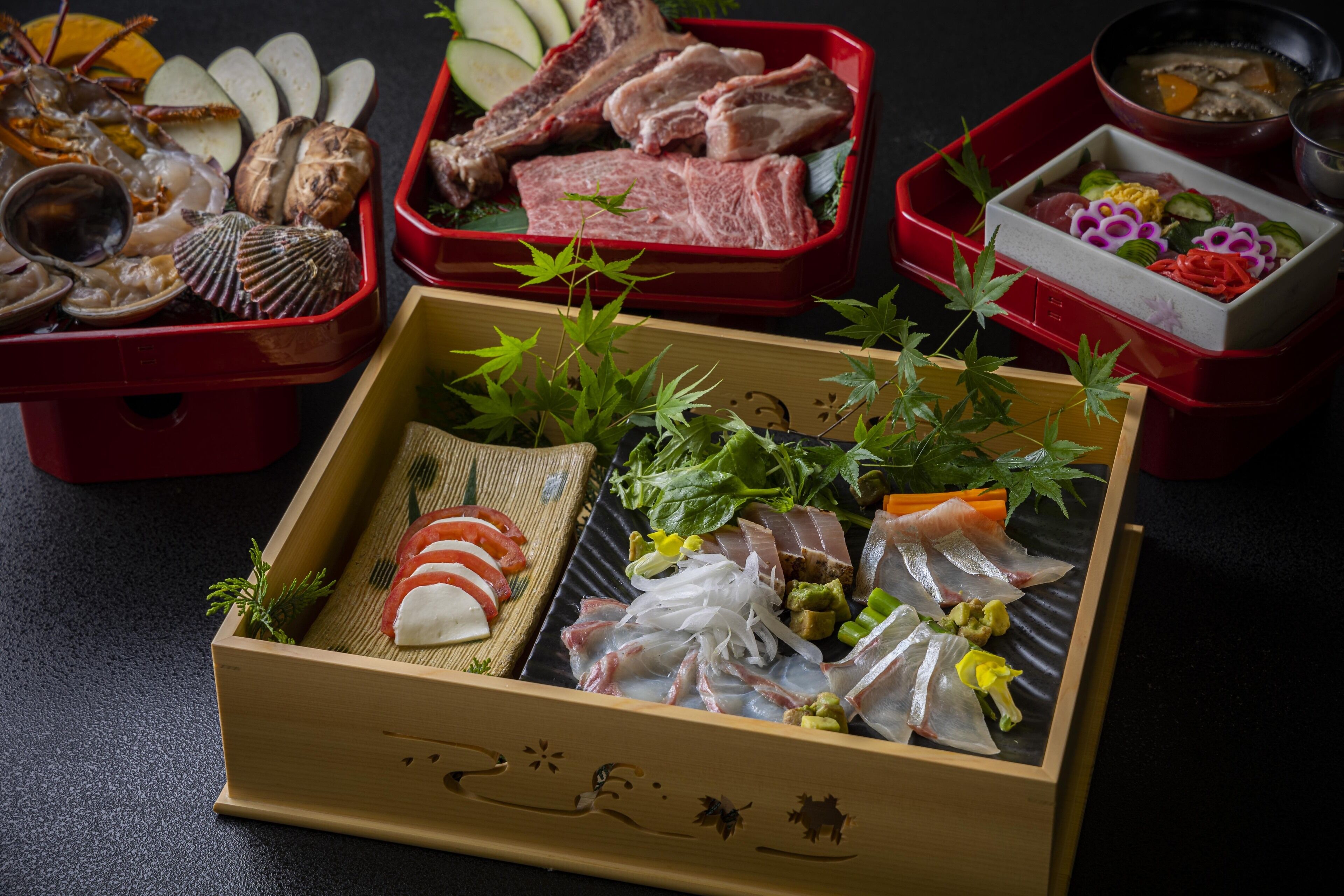 A variety of seafood and meat dishes in traditional Japanese bento boxes.