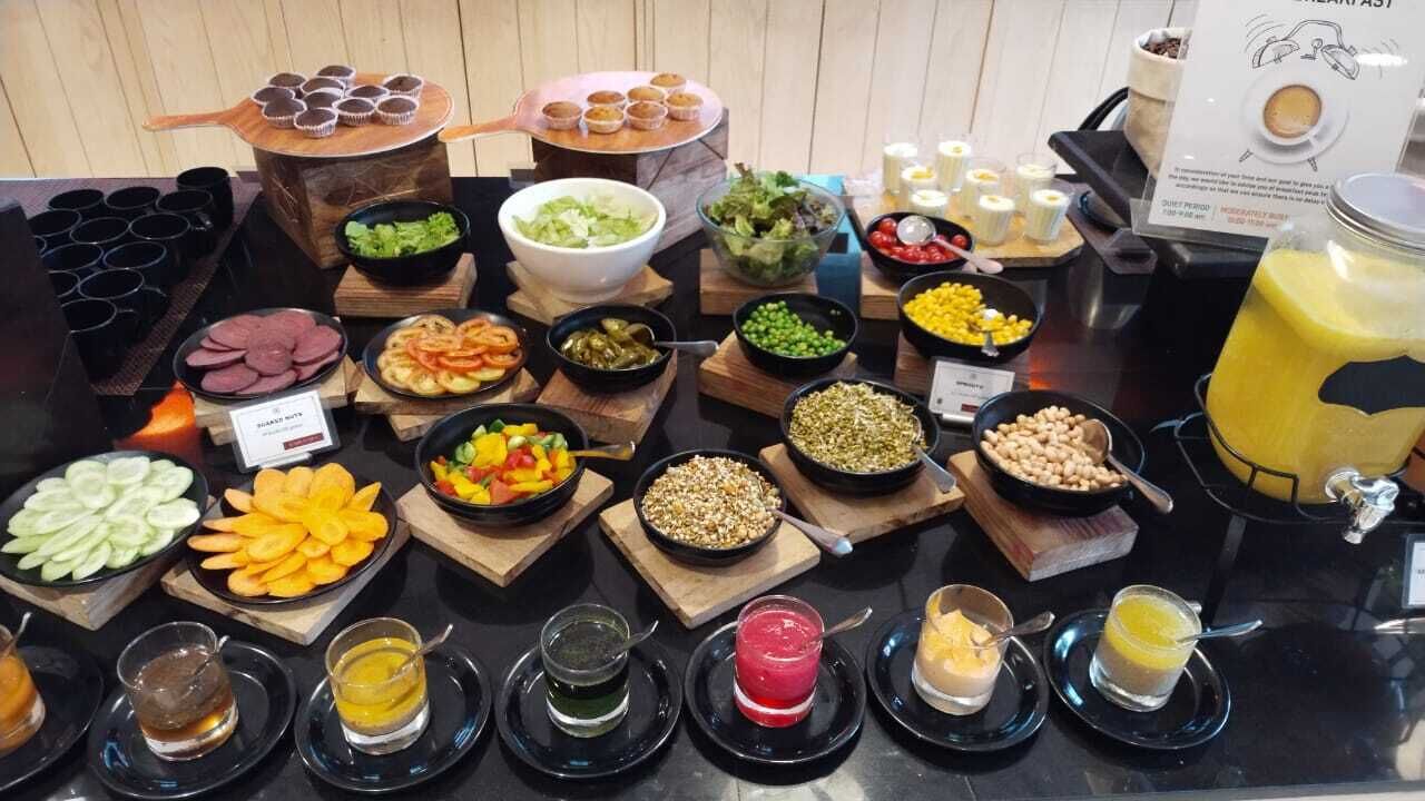 A buffet with various food items and condiments.