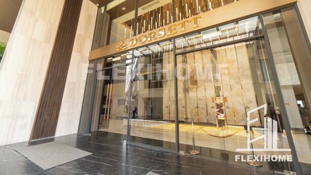 A modern building entrance with a glass facade and a sign reading "DORSETT". - Dorsett Residences, Sri Hartamas-KL, Hotel Theme Studio Homes by Flexihome-MY (Kuala Lumpur)