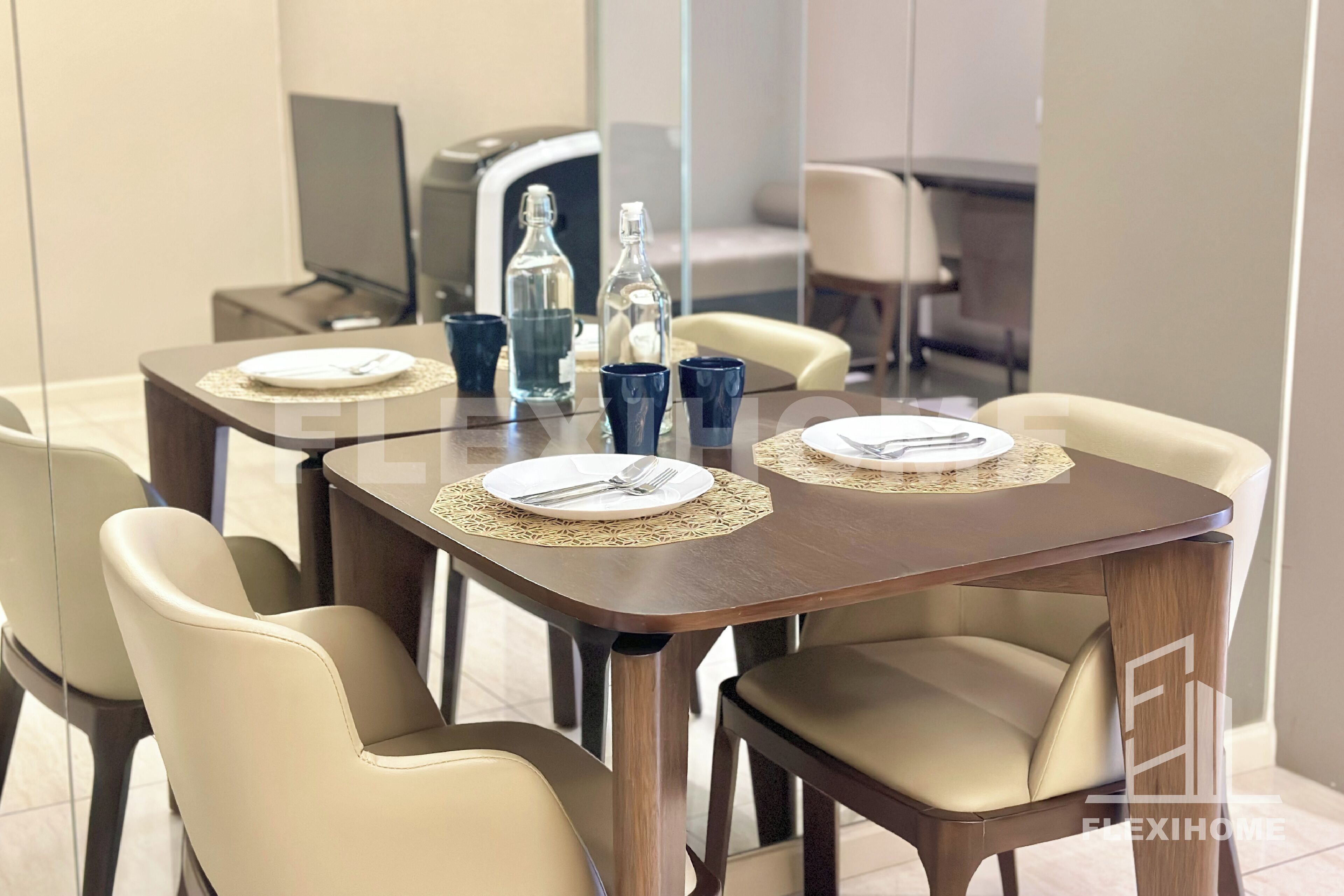 A dining area with a wooden table, four beige chairs, and a glass partition.