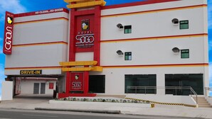 A hotel with a '50 CLEAN...so good!' sign, a drive-in entrance, and a red and yellow facade. - Hotel Sogo General Trias (General Trias)