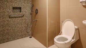 A bathroom with a shower, toilet, and a hand dryer. - Hotel Sogo General Trias (General Trias)