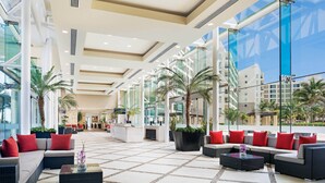 A spacious lobby with modern furnishings, large windows, and indoor plants. - Westin Lagunamar Ocean Resort - Luxurious 1-Bedroom Villa - Family Friendly Resort! (Cancun)