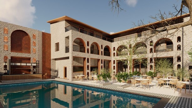 A poolside area with outdoor seating and a stone building with arches. - Jewels Resorts (Jaipur)