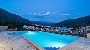 Seasonal outdoor pool, an infinity pool, pool umbrellas, pool loungers