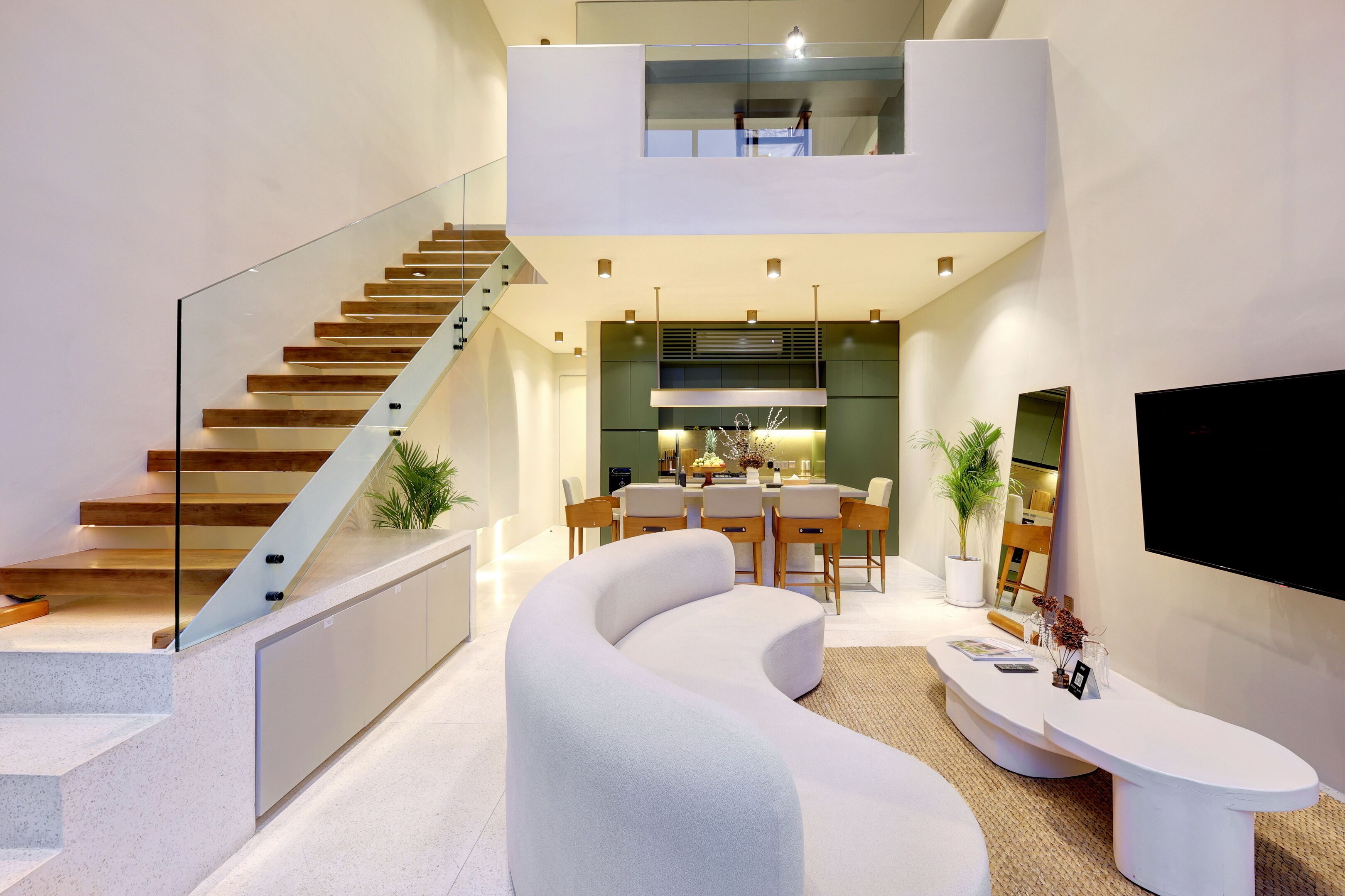 A modern interior with a staircase, a dining area, and a living space.