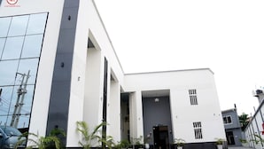 A modern building with a white facade, large windows, and a flat roof. - GRACIAS HOTEL AND SUITES (Lekki)
