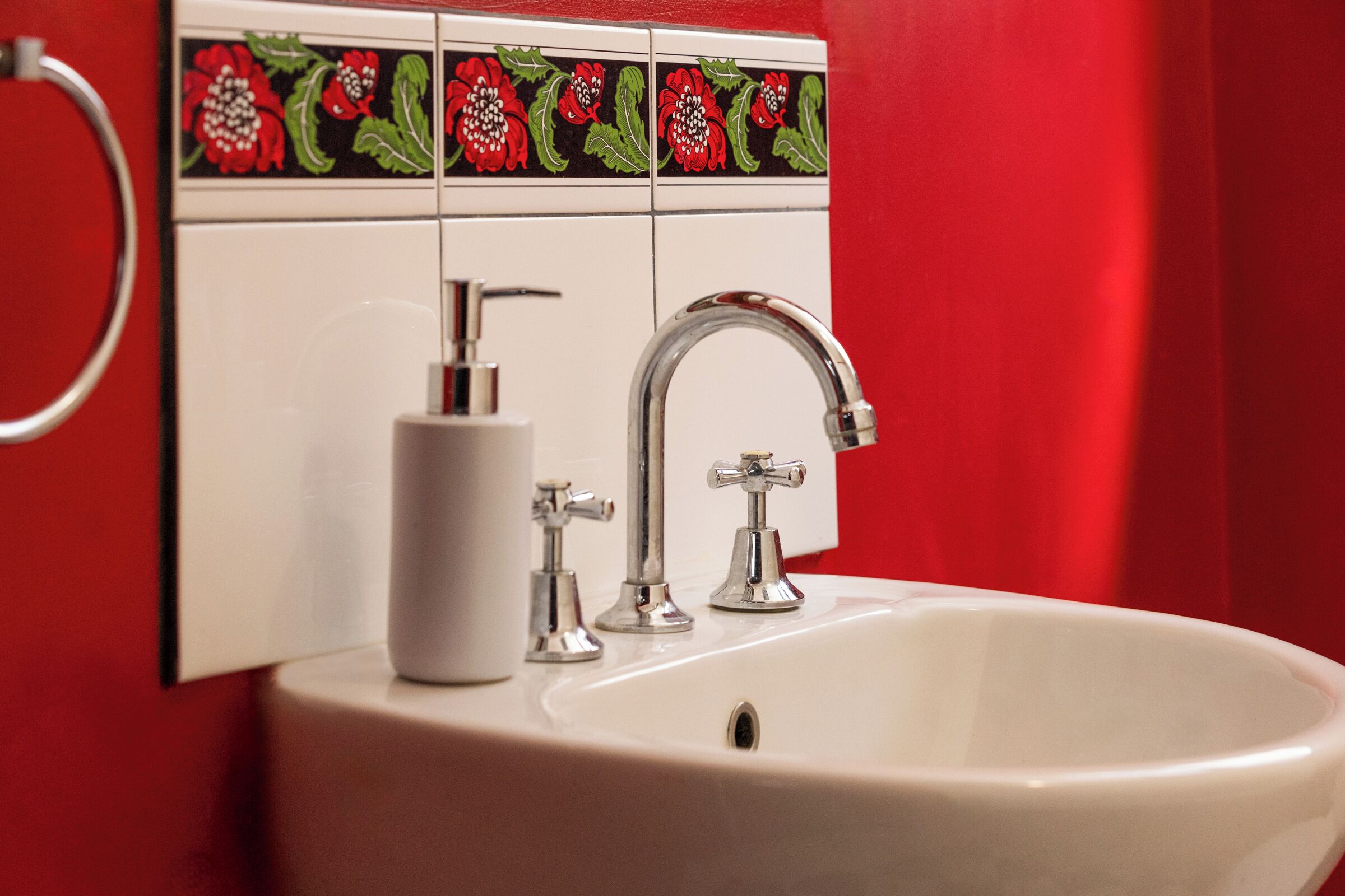 A bathroom sink with a modern faucet and a soap dispenser.