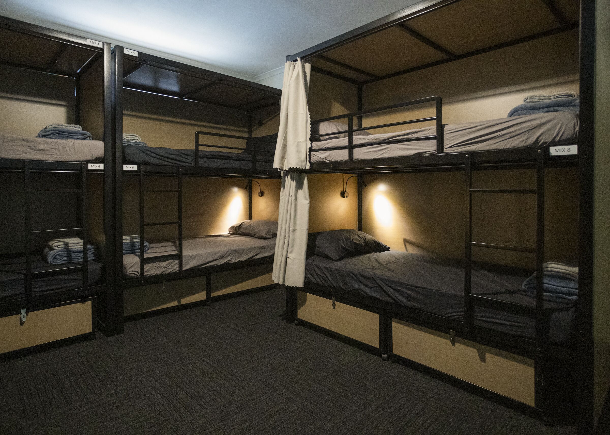 A bunk bed room with multiple beds, each labeled with a mix number.