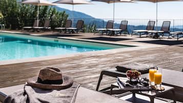 Seasonal outdoor pool, open 9:00 AM to 7:30 PM, pool umbrellas