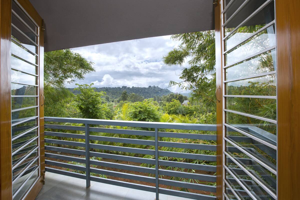 Un balcón con vistas a un paisaje verde exuberante y un cielo nublado.