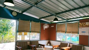 A room with wooden furniture, a clock, and a calendar on the wall. - TGI Kairos (Tirupattur)