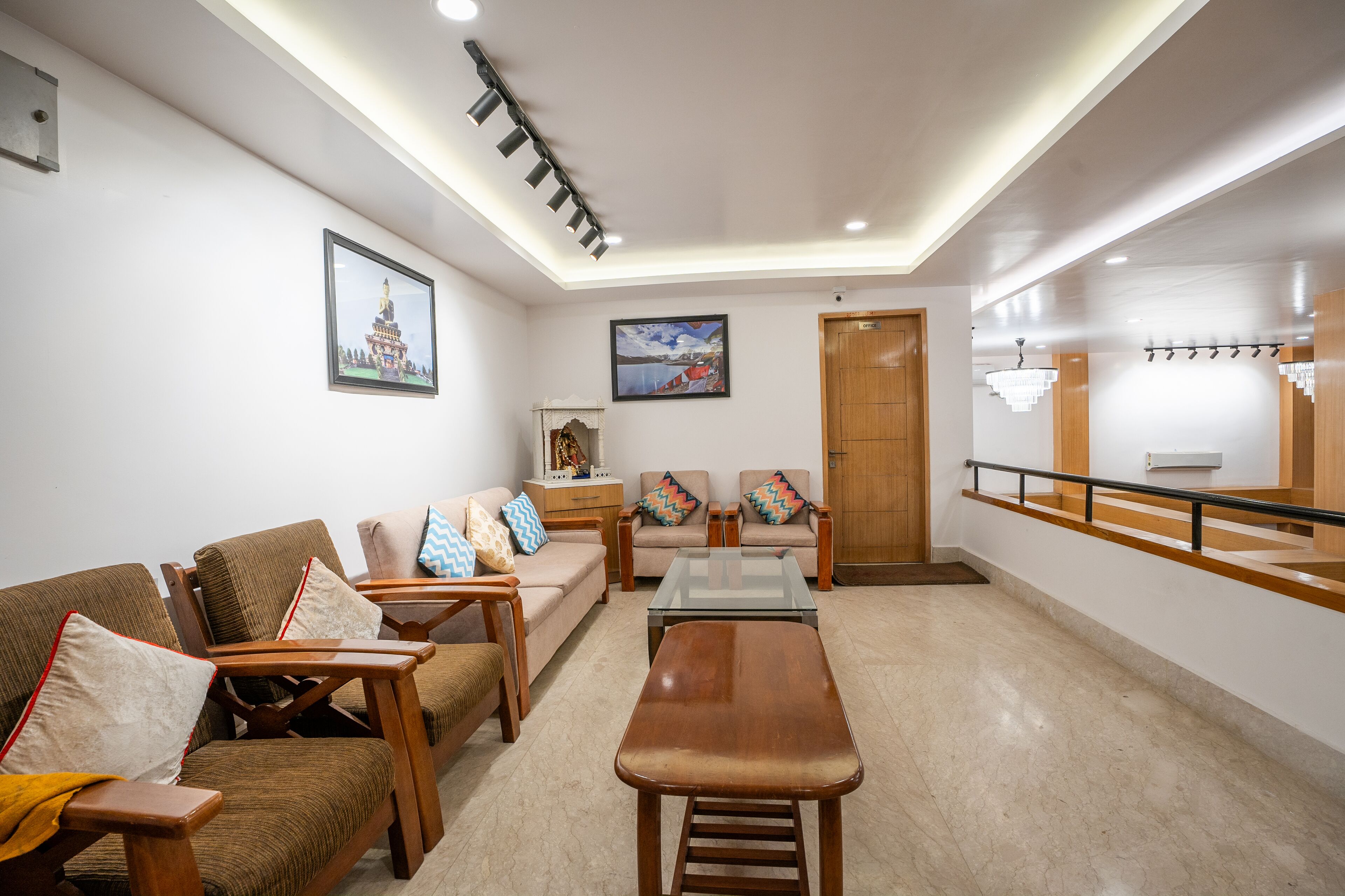 A modern living room with a sofa, chairs, a coffee table, and a wooden bench.