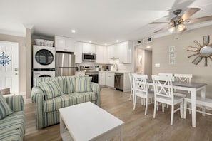 A compact kitchen with a built-in oven, microwave, and dishwasher.
