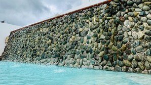 A stone wall with a tiled roof edge.
