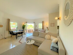 A modern living room with a sofa, coffee table, and dining area. - T-0322, Mariposa, Modern villa in Dènia (Dénia)