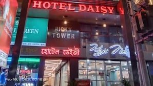 The exterior of Hotel Daisy with illuminated signage, a visible shop on the ground floor, and a clear view of the building's facade. - Hotel Daisy (Guwahati)