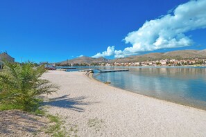 A coastal area with a clear sky, calm water, and a small dock.