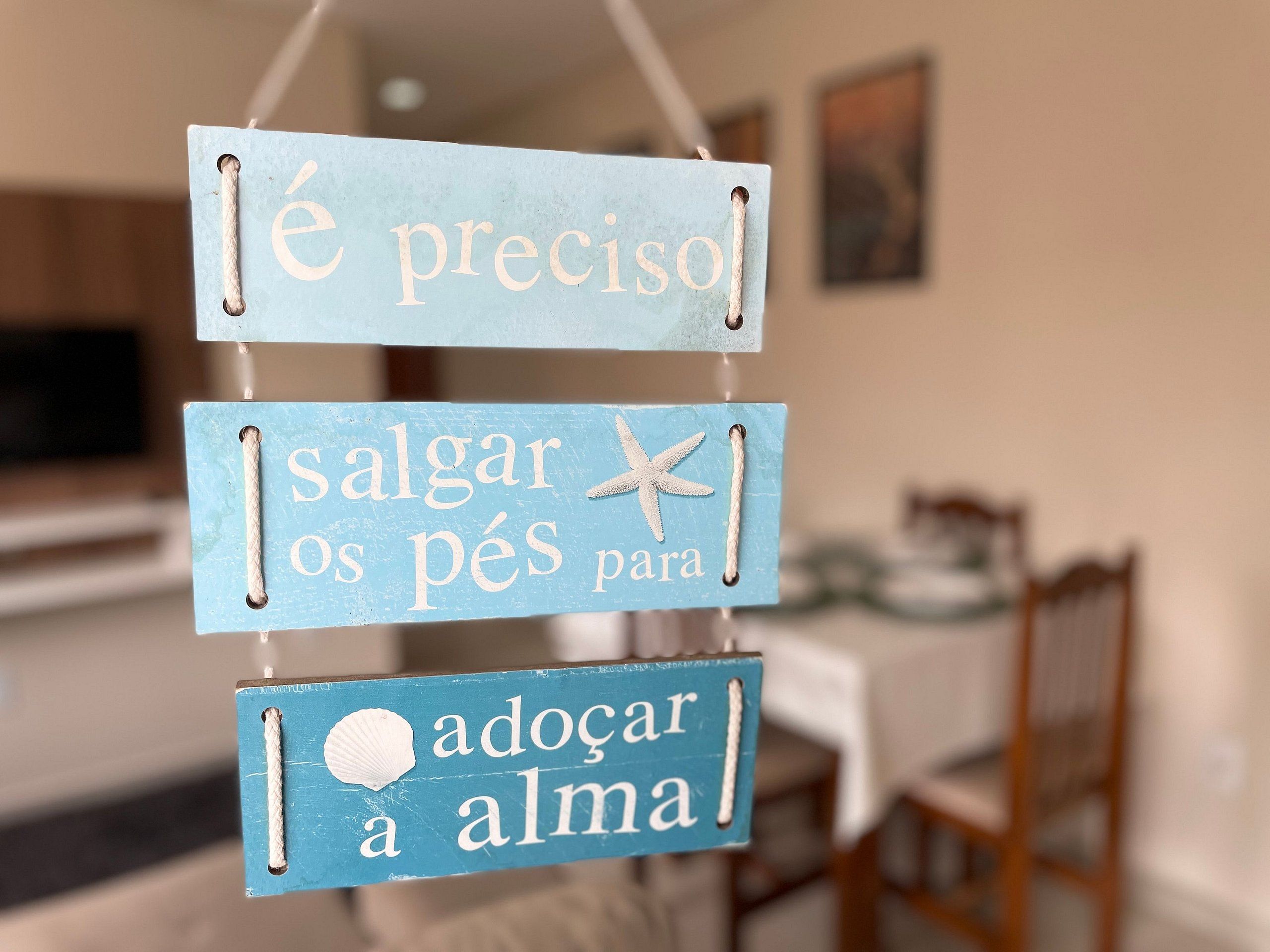 A sign with three blue panels, each with white text and a small starfish decoration.