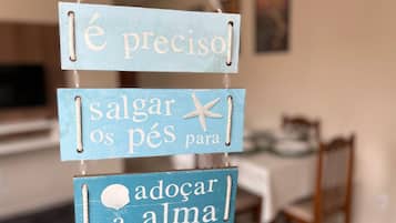 A sign with three blue panels, each with white text and a small starfish decoration.