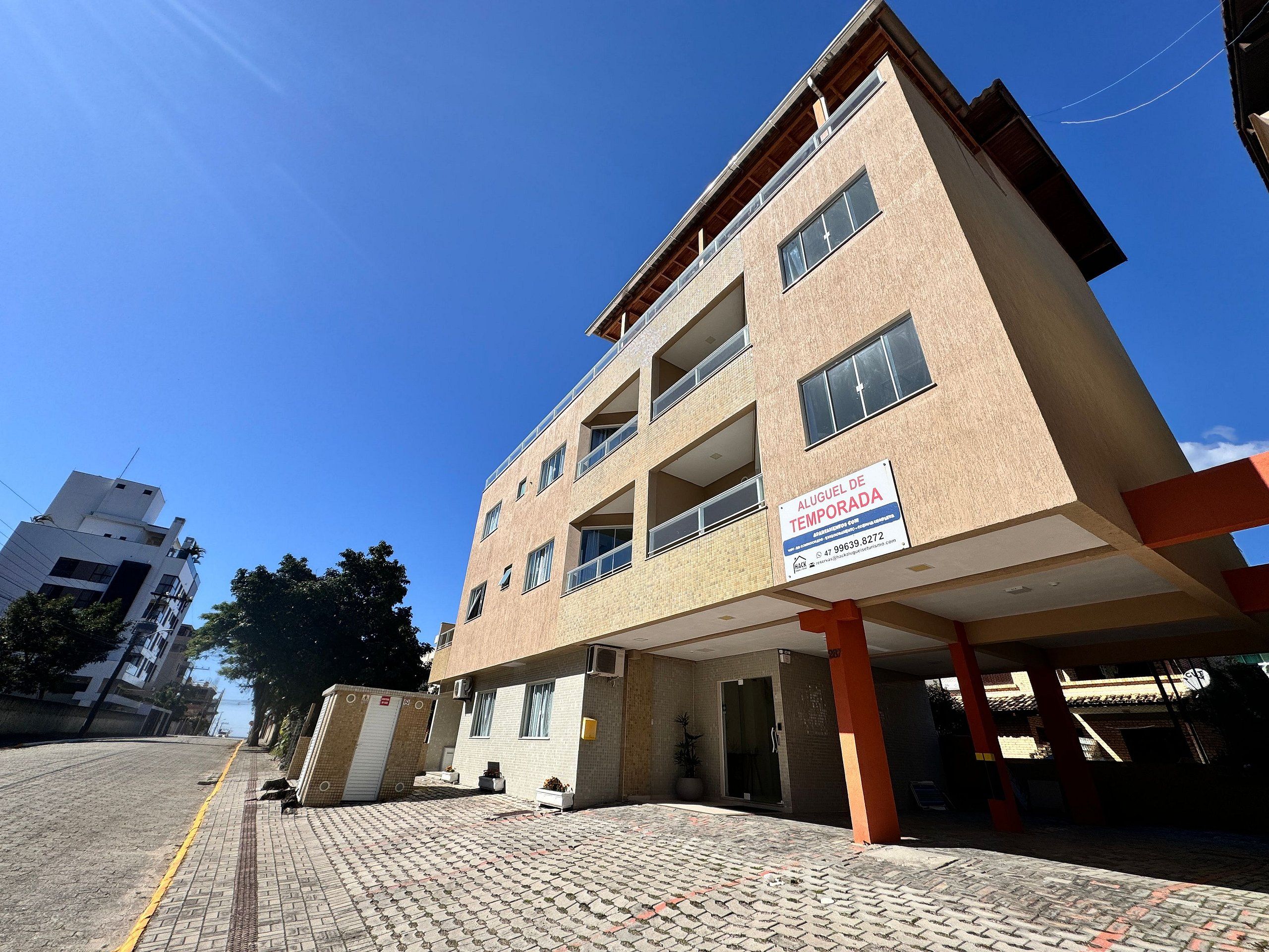 A multi-story building with a sign indicating it is a temporary lodging.