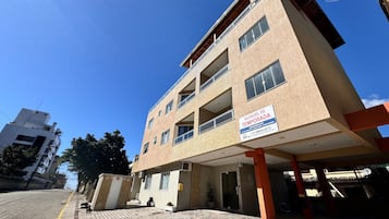 A multi-story building with a sign indicating it is a temporary lodging.