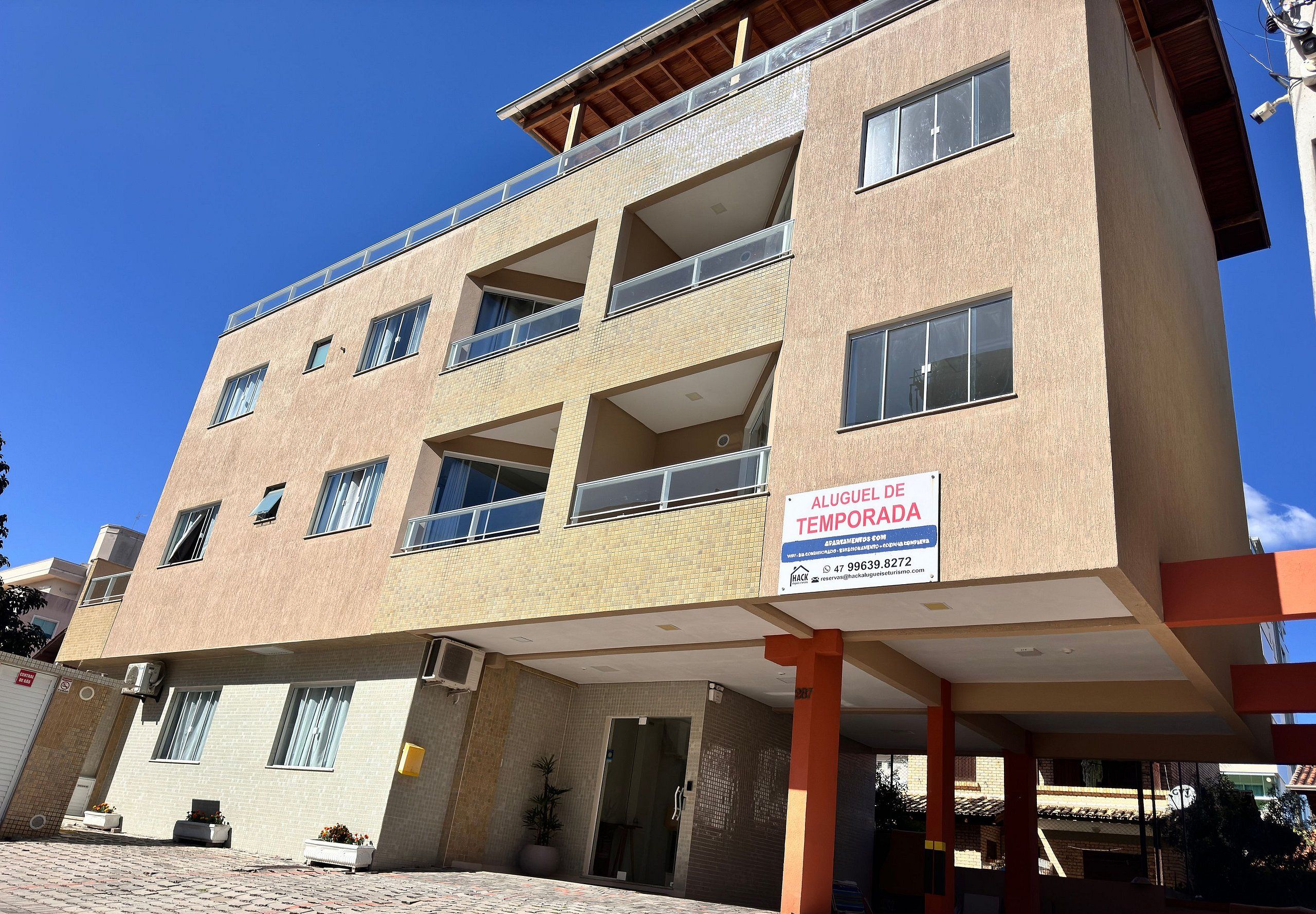 A multi-story building with a sign indicating it is a temporary lodging.