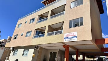 A multi-story building with a sign indicating it is a temporary lodging.