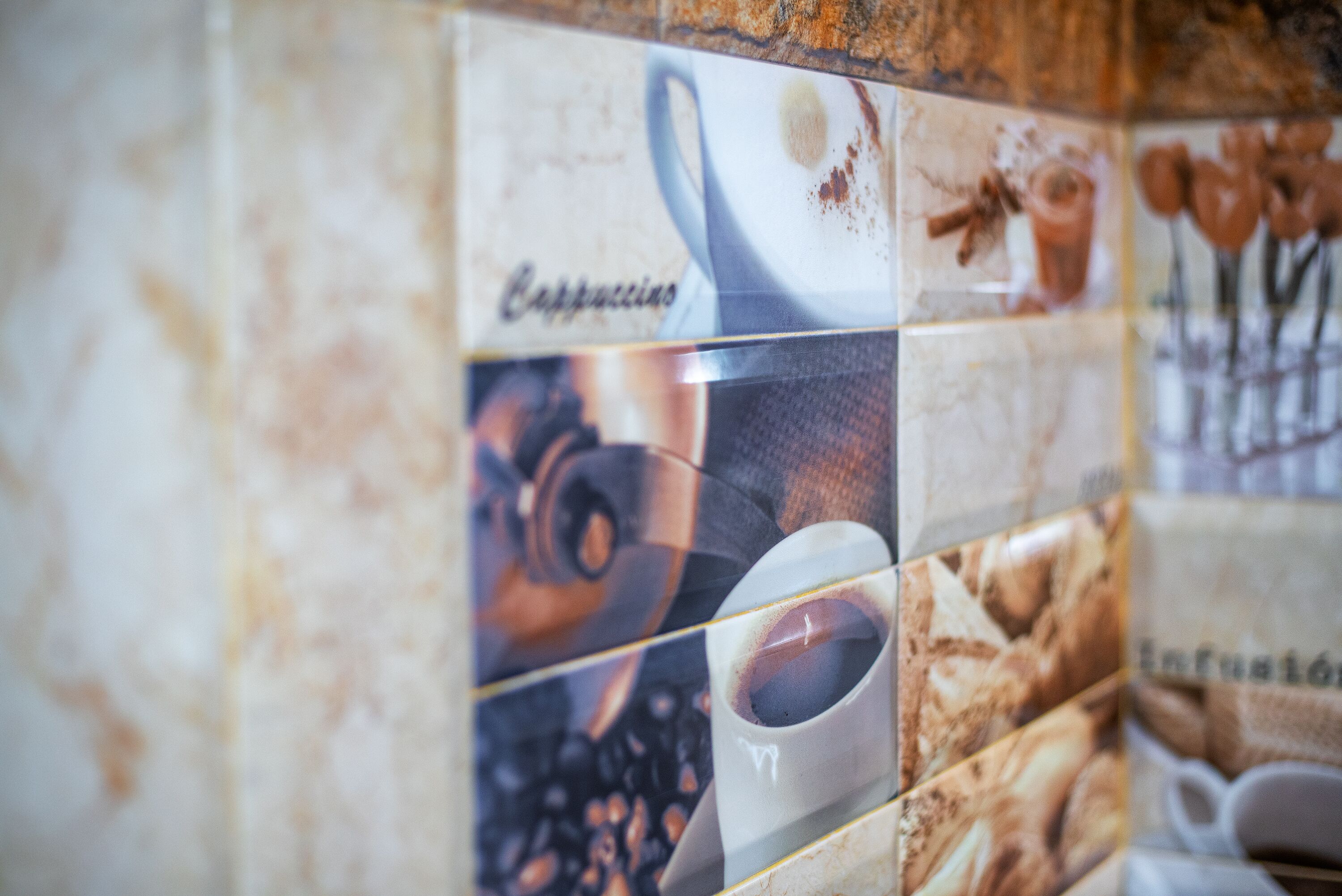 A tiled wall with a coffee advertisement.