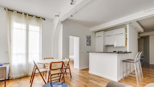 A modern apartment with a dining area, kitchen, and living space. - A Nice 1-BR in Saint-Germain (Paris)