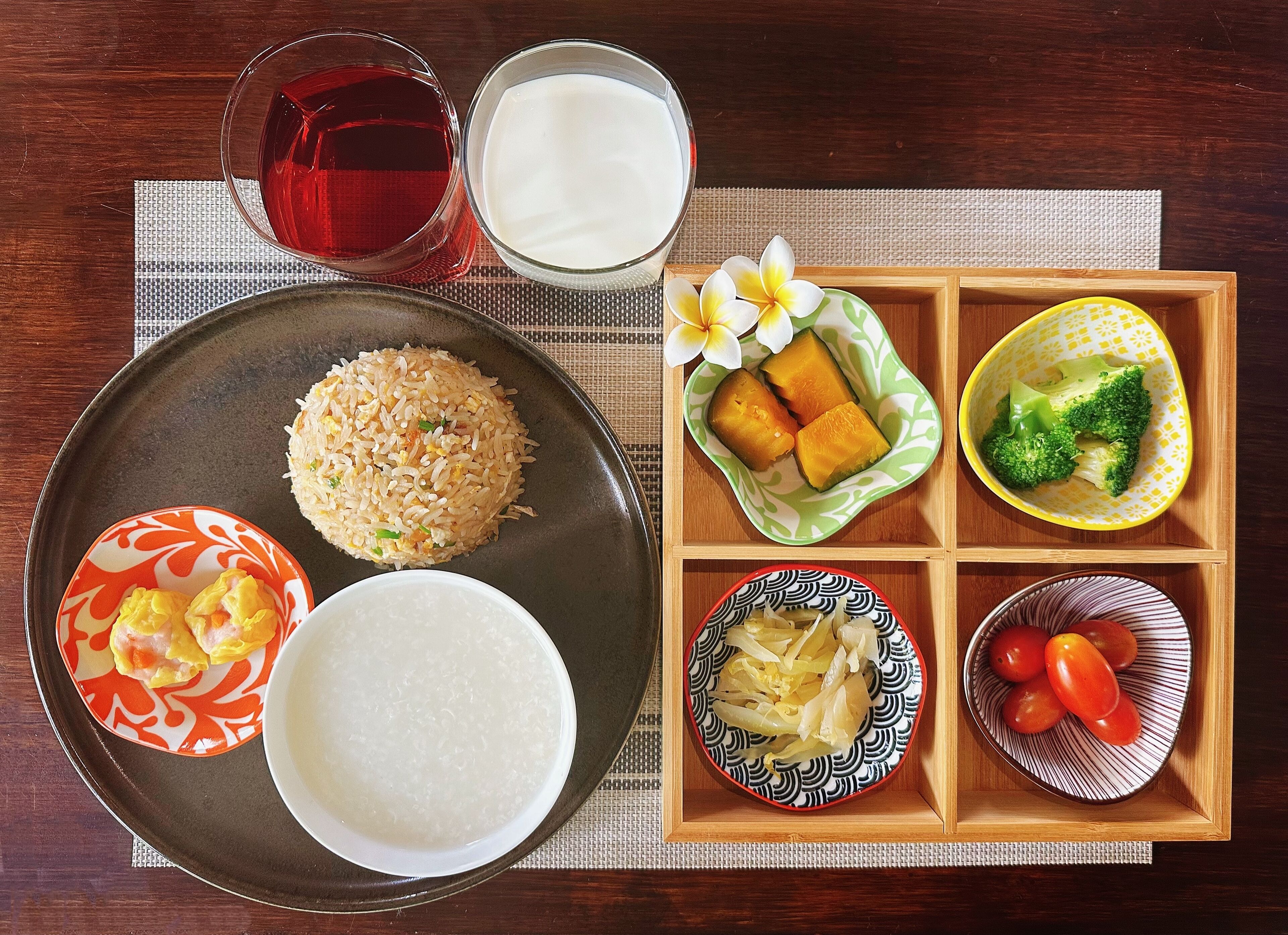 A meal with rice, eggs, and vegetables on a tray.