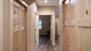 A hallway with wooden doors and a wooden floor. - New! 4BR Lake Namakagon Cabin - Sleeps 15 - Lakefront w/ boat access (Cable)