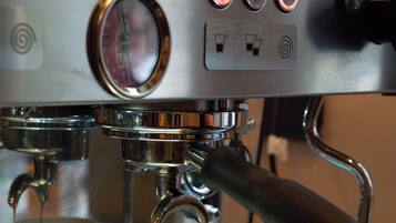 A coffee machine with a digital display and control buttons.